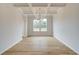Elegant dining room featuring hardwood floors, coffered ceiling, chandelier, and natural light at 247 Arnewood Cir, Mcdonough, GA 30253
