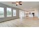 Bright and airy living room with large windows, hardwood floors, and an open view to the kitchen at 247 Arnewood Cir, Mcdonough, GA 30253