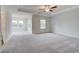 Spacious main bedroom with tray ceiling, ceiling fan, and large windows for plenty of light at 247 Arnewood Cir, Mcdonough, GA 30253