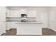 Kitchen with white cabinets, island, stainless steel appliances and laminate flooring at 372 Sound Cir, Stockbridge, GA 30281