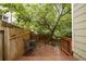 Charming backyard deck with seating area, surrounded by lush landscaping and a wooden fence at 615 Sycamore Dr, Decatur, GA 30030