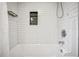 Clean bathroom with white subway tile, a shower and tub, and a convenient shower caddy at 615 Sycamore Dr, Decatur, GA 30030