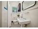 Charming bathroom featuring a pedestal sink and black-and-white hexagon tile flooring at 615 Sycamore Dr, Decatur, GA 30030
