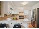 Well-equipped kitchen with white cabinets, stainless steel appliances, tile countertops, and a convenient breakfast bar at 615 Sycamore Dr, Decatur, GA 30030