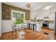 Cozy eat-in kitchen with wood floors, white cabinets, stainless steel appliances, and eye-catching wallpaper at 615 Sycamore Dr, Decatur, GA 30030