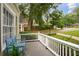 Inviting covered porch with a charming blue bench, white railings, and lush landscaping at 615 Sycamore Dr, Decatur, GA 30030