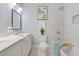 Bright bathroom featuring double vanity, tub with tiled shower, and modern fixtures at 1363 Jonesboro Se Rd, Atlanta, GA 30315
