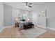 Light-filled bedroom with hardwood floors, ceiling fan, and a large window at 1363 Jonesboro Se Rd, Atlanta, GA 30315