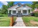Charming home featuring a welcoming walkway, beautiful lawn, and classic black and white accents at 1363 Jonesboro Se Rd, Atlanta, GA 30315