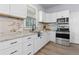 Bright kitchen features white cabinets, stainless steel appliances, and granite countertops at 1363 Jonesboro Se Rd, Atlanta, GA 30315
