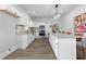 Bright, modern kitchen features an island, granite countertops, stainless steel appliances, and white cabinets at 1363 Jonesboro Se Rd, Atlanta, GA 30315