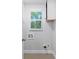 Functional laundry room with a window, utility hookups, and a cabinet at 1363 Jonesboro Se Rd, Atlanta, GA 30315