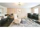 Bright living room with a modern light fixture and comfortable seating at 3302 Waldrop Trl, Decatur, GA 30034