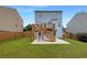 Backyard with a well-maintained lawn, wooden deck and stairs leading to the upper level of the home at 3695 Santa Rosa Way, Douglasville, GA 30135