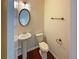 Powder room with a pedestal sink and toilet, complemented by classic fixtures and finishes at 3695 Santa Rosa Way, Douglasville, GA 30135
