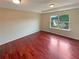 Spacious bedroom with hardwood floors, a tray ceiling, and a window offering ample natural light at 3695 Santa Rosa Way, Douglasville, GA 30135