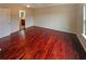 A primary bedroom with hardwood floors, a large window and en-suite bathroom at 3695 Santa Rosa Way, Douglasville, GA 30135