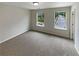 A secondary bedroom with wall-to-wall carpeting and two windows at 3695 Santa Rosa Way, Douglasville, GA 30135