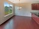 Bright dining area featuring hardwood floors, wainscoting, a chandelier, and large windows at 3695 Santa Rosa Way, Douglasville, GA 30135