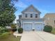 Charming two-story home with a two-car garage, blue siding, and a well-manicured lawn, creating an inviting curb appeal at 3695 Santa Rosa Way, Douglasville, GA 30135