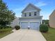 Charming two-story home with blue siding, manicured lawn, and two-car garage at 3695 Santa Rosa Way, Douglasville, GA 30135