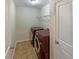A fully equipped laundry room with a full-size washer and dryer at 3695 Santa Rosa Way, Douglasville, GA 30135