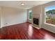 Bright living room featuring hardwood floors, a fireplace, and large windows with views of the outdoors at 3695 Santa Rosa Way, Douglasville, GA 30135