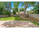 A home's backyard includes a stone patio area and grass at 615 Rosedown Way, Alpharetta, GA 30022