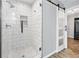Elegant bathroom with a sliding glass shower door, white subway tile, and decorative niche at 615 Rosedown Way, Alpharetta, GA 30022