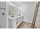 Bright bathroom features a double vanity with sleek hardware and wood-look tile flooring at 615 Rosedown Way, Alpharetta, GA 30022