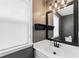 Bathroom features a dark framed mirror, great lighting, and a vanity area at 615 Rosedown Way, Alpharetta, GA 30022