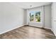 Bright bedroom with neutral walls, new flooring, and a window showcasing the neighborhood at 615 Rosedown Way, Alpharetta, GA 30022