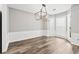 Elegant dining room with modern light fixture, hardwood floors, and decorative trim at 615 Rosedown Way, Alpharetta, GA 30022