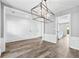 Spacious dining area with wood floors, modern lighting, and white trim details at 615 Rosedown Way, Alpharetta, GA 30022
