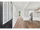 Bright entryway featuring hardwood floors, white trim, and view to kitchen at 615 Rosedown Way, Alpharetta, GA 30022