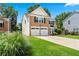 Attractive brick and siding home with a two-car garage, showcasing a green lawn at 615 Rosedown Way, Alpharetta, GA 30022