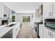Bright kitchen features stone countertops, stainless appliances, and modern cabinetry at 615 Rosedown Way, Alpharetta, GA 30022