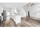 Bright, open kitchen with white cabinets, stainless appliances, and stylish wood flooring at 615 Rosedown Way, Alpharetta, GA 30022