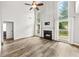 Bright living room boasts tall windows, wood flooring, and a striking fireplace feature at 615 Rosedown Way, Alpharetta, GA 30022