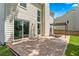 Brick patio with a pergola, a fire pit, and sliding door access to the home's interior at 615 Rosedown Way, Alpharetta, GA 30022