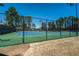 A community tennis court with green and blue surface at 615 Rosedown Way, Alpharetta, GA 30022