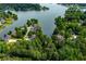 Picturesque aerial view of waterfront homes, docks, and a lake surrounded by dense, mature trees at 9018 Lakeview Pkwy, Villa Rica, GA 30180