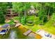 Aerial view of a lakefront property featuring a house, dock, gazebo, and sandy beach area at 9018 Lakeview Pkwy, Villa Rica, GA 30180