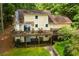 Two-story home featuring an expansive deck overlooking a landscaped backyard at 9018 Lakeview Pkwy, Villa Rica, GA 30180