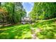 Beautifully landscaped backyard with a lush lawn and mature trees at 9018 Lakeview Pkwy, Villa Rica, GA 30180