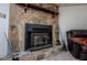 Basement fireplace featuring stonework, a rustic wood mantel, and lots of natural light at 9018 Lakeview Pkwy, Villa Rica, GA 30180