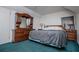 Bedroom features teal carpet and dark wood bedroom furniture at 9018 Lakeview Pkwy, Villa Rica, GA 30180