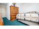 Bedroom with teal carpet and medium wood bedroom furniture at 9018 Lakeview Pkwy, Villa Rica, GA 30180