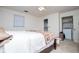 Bedroom featuring a decorative quilt, ceiling fan, and in-suite laundry at 9018 Lakeview Pkwy, Villa Rica, GA 30180
