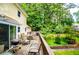 An expansive deck with outdoor furniture offers stunning views of the landscaped yard and lush greenery at 9018 Lakeview Pkwy, Villa Rica, GA 30180